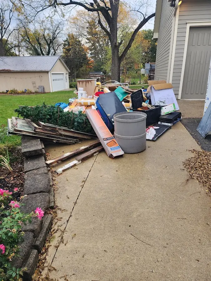 Dumpster being loaded with debris for Roofing Dumpster Rental in Seward